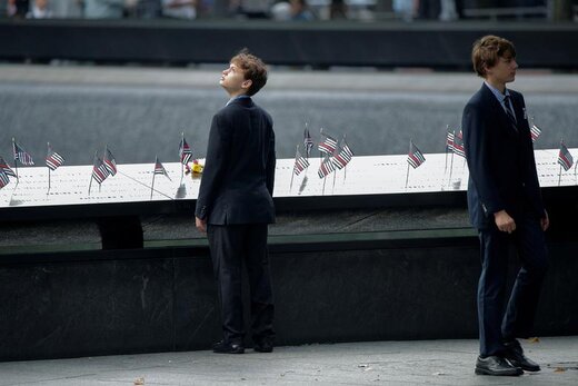 دو پسر در هجدهمین یادبود حملات 11 سپتامبر در کنار استخری در نیویورک ایستاده‌اند