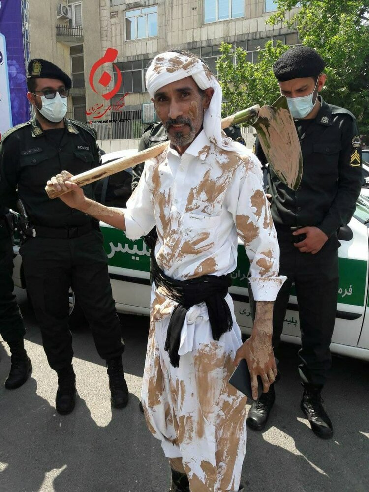 عکس | داوطلبی با کلنگ و لباسی گلی در ستاد انتخابات