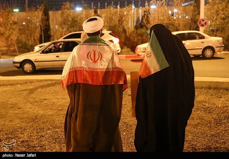 عکس| یک روحانی در مراسم استقبال از تیم ملی با پرچم ایران