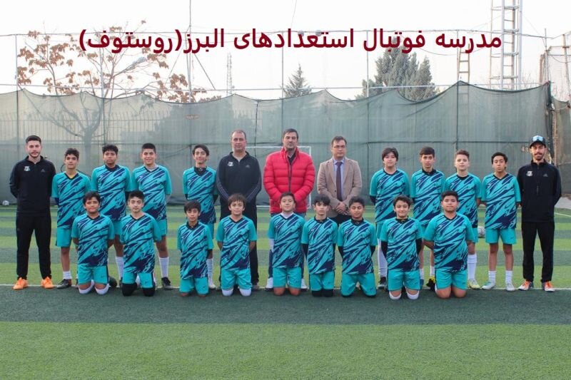 عکس تیمی فوتبالیستهای نوجوان ایران روستوف با لباس آبی در زمین چمن به همراه مربیان و نیما نکیسا