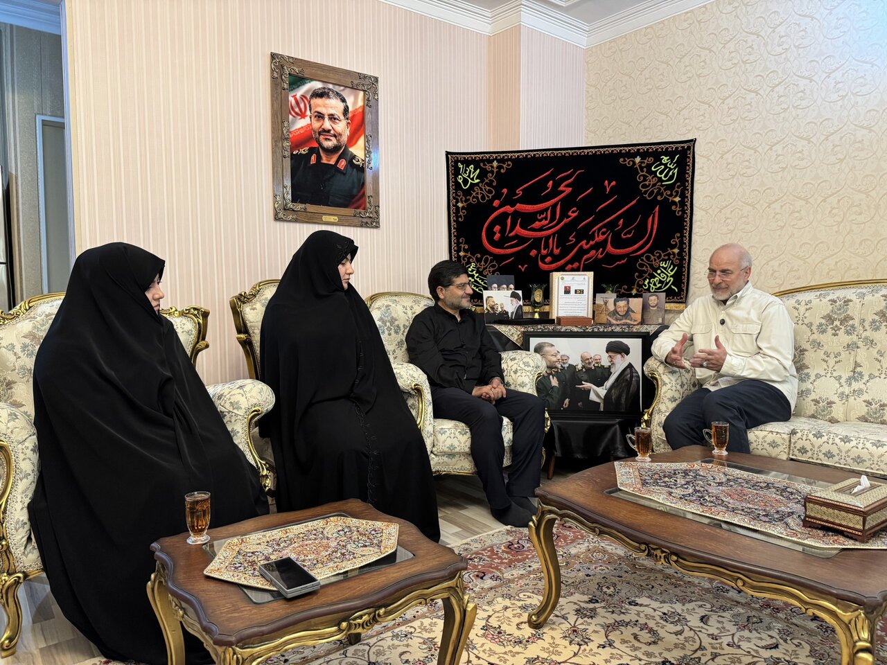 تصاویر حضور قالیباف در منزل رئیس شهید سازمان بسیج مستضعفین؛ از عکس دسته جمعی شهید سلیمانی، شهید سلامی و رهبر شهید تا گفت وگوی رئیس مجلس با خانواده