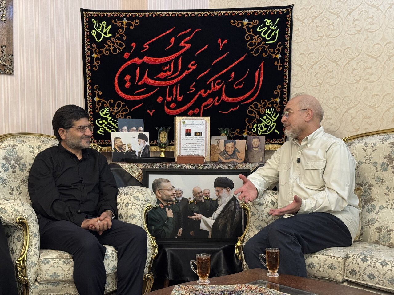 تصاویر حضور قالیباف در منزل رئیس شهید سازمان بسیج مستضعفین؛ از عکس دسته جمعی شهید سلیمانی، شهید سلامی و رهبر شهید تا گفت وگوی رئیس مجلس با خانواده